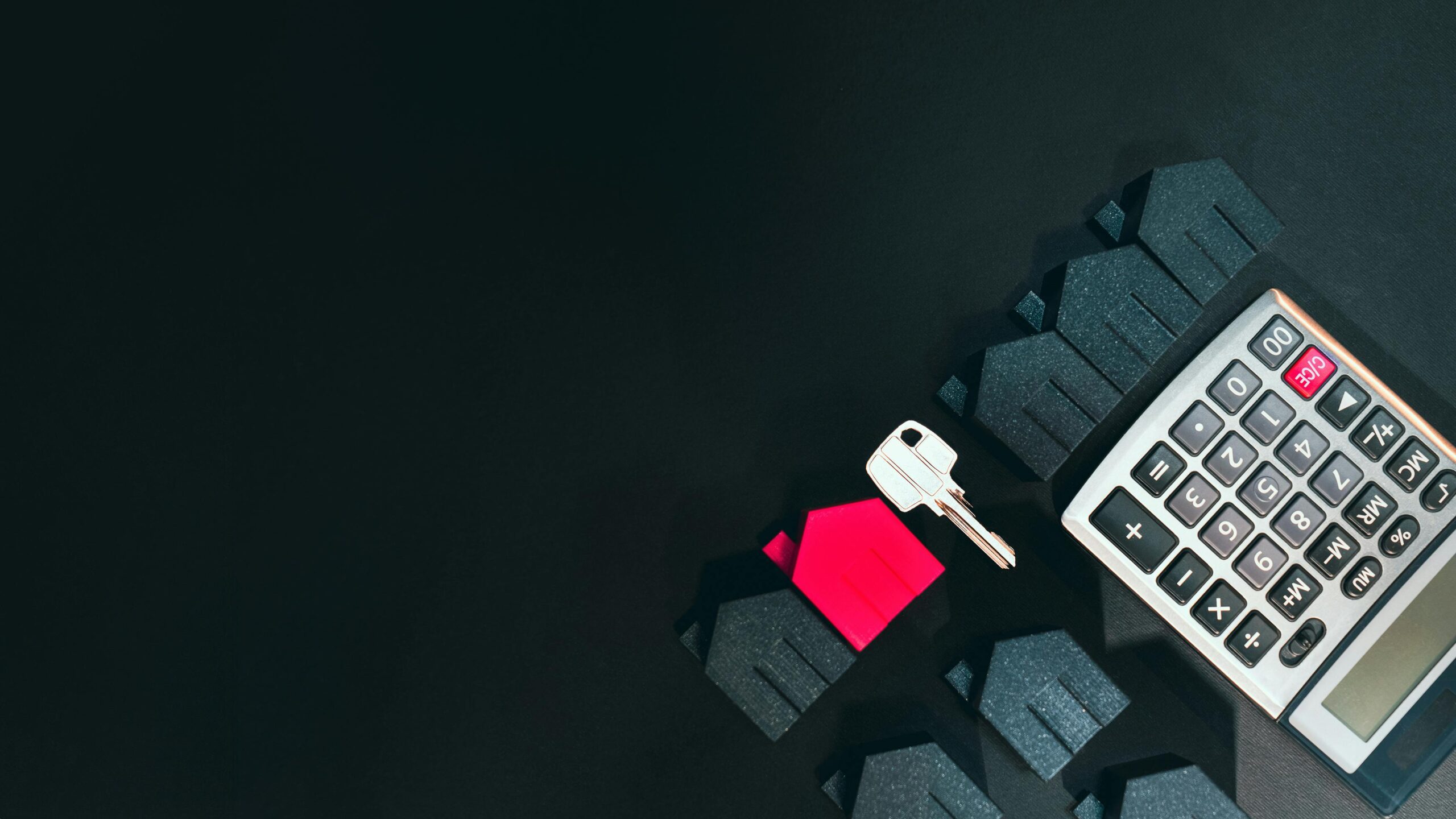 calculator and door key representing home sale