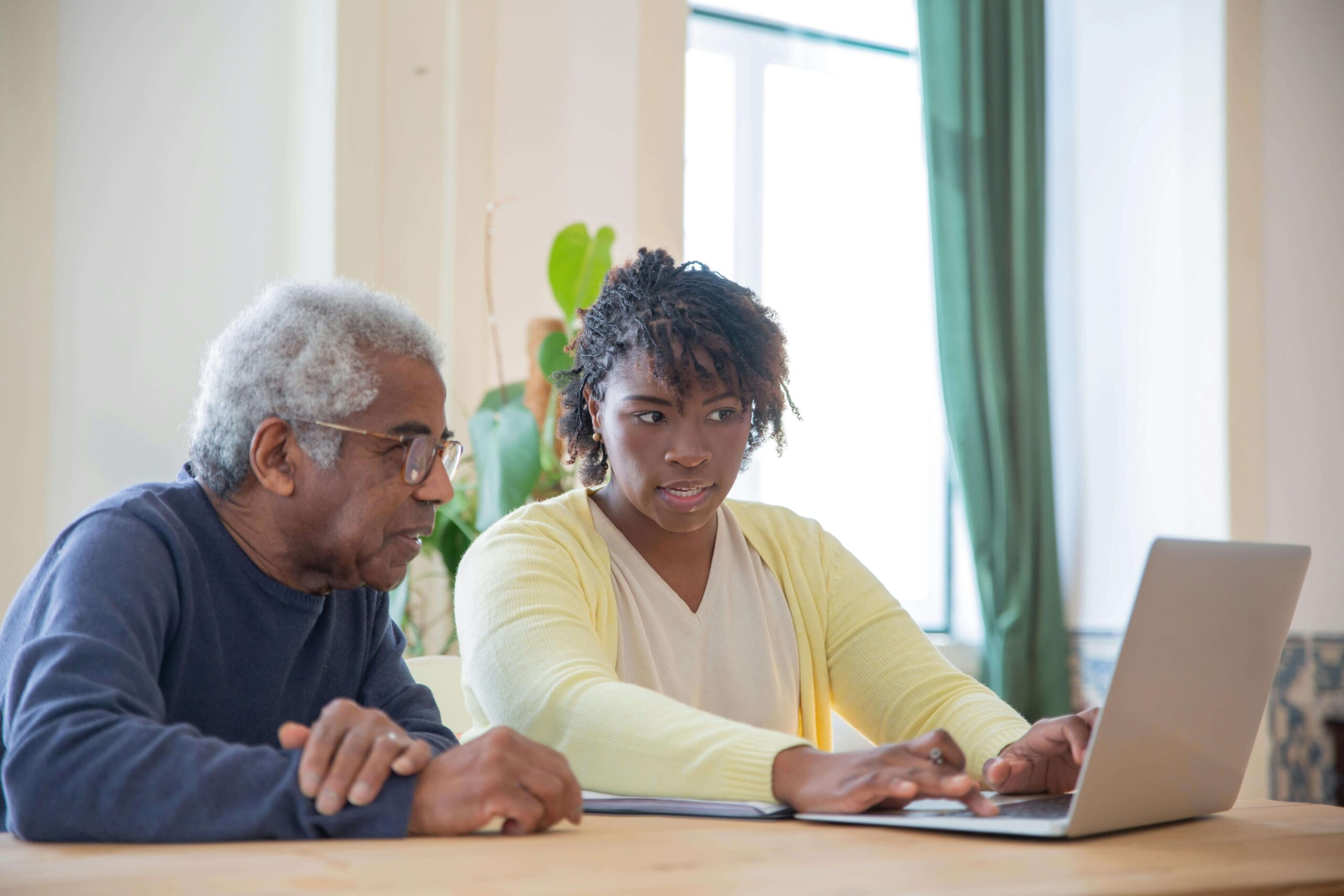 man and a woman using a laptop together